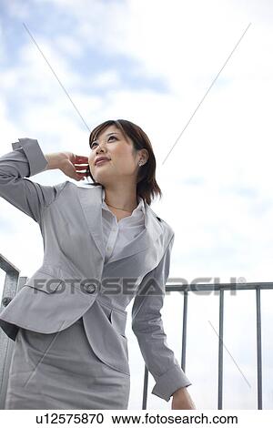 Stock Image - Young businesswoman looking away. Fotosearch