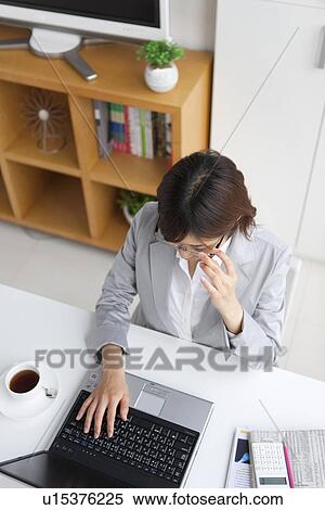 Young businesswoman using laptop View Large Photo Image Stock Photography - Young businesswoman using laptop. Fotosearch