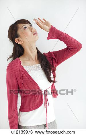 Young woman applying eye drops, white background View Large Photo Image Stock Image - Young woman applying eye drops, white background. Fotosearch