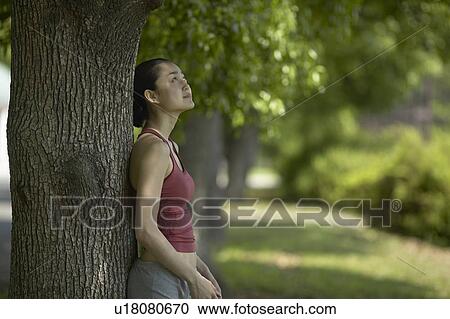 Young Woman Leaning Against A Tree View Large Photo Image Stock Image - Young Woman Leaning Against A Tree. Fotosearch