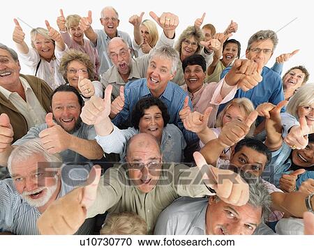 Stock Image - A group of people giving the thumbs up sign. Fotosearch