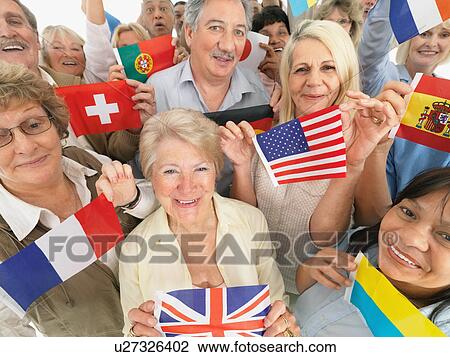 A group of people holding small flags View Large Photo Image Stock Image - A group of people holding small flags. Fotosearch