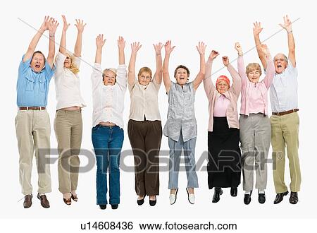 Stock Photograph - A group of people jumping with their arms raised. Fotosearch
