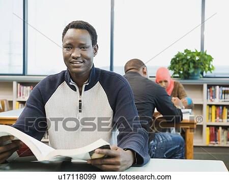 Adult sitting at desk at learning center View Large Photo Image Stock Photo - Adult sitting at desk at learning center. Fotosearch