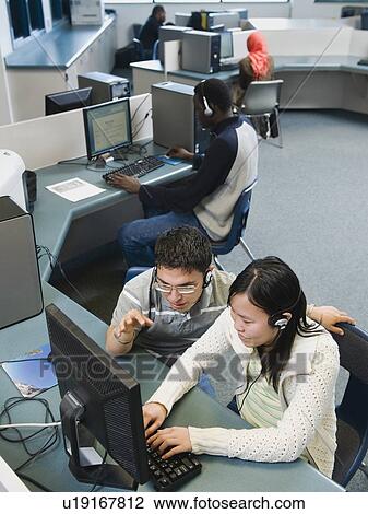 Adult students working on computers at a learning center View Large Photo Image Stock Image - Adult students working on computers at a learning center. Fotosearch