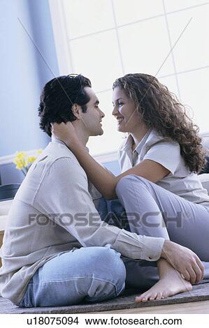 Affectionate couple sitting on floor in their home View Large Photo Image Picture - Affectionate couple sitting on floor in their home. Fotosearch