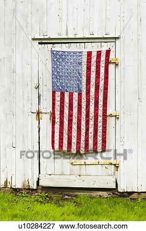 Stock Photo - American flag draped on door of barn. Fotosearch