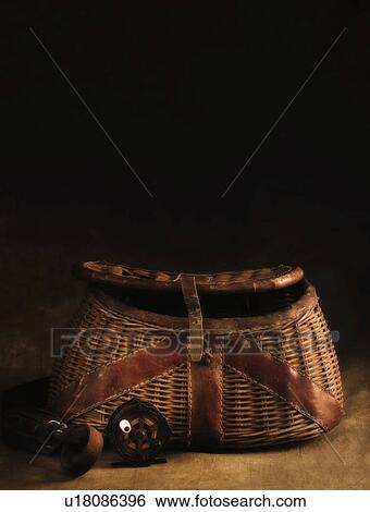 Stock Photograph - Antique fishing basket and reel. Fotosearch