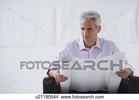 Architect looking at house plans View Large Photo Image Picture - Architect looking at house plans. Fotosearch