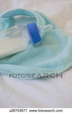 Baby bottle and bib View Large Photo Image Stock Photo - Baby bottle and bib. Fotosearch