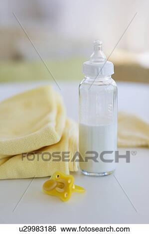 Stock Photograph - Baby bottle pacifier and blanket. Fotosearch