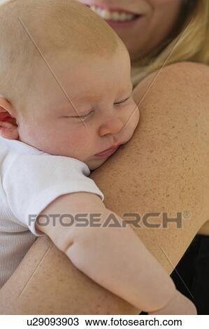 Baby sleeping in mother's arms View Large Photo Image Stock Image - Baby sleeping in mother's arms. Fotosearch
