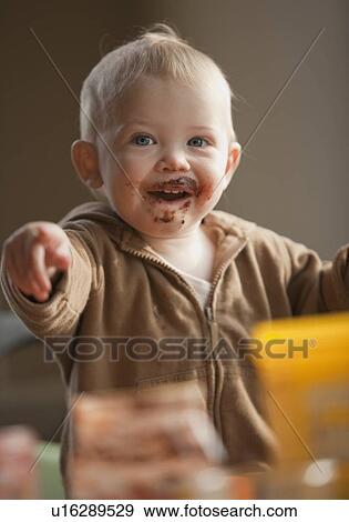 Baby with messy face View Large Photo Image Stock Photo - Baby with messy face. Fotosearch