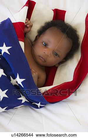 Baby wrapped in American flag View Large Photo Image Picture - Baby wrapped in American flag. Fotosearch