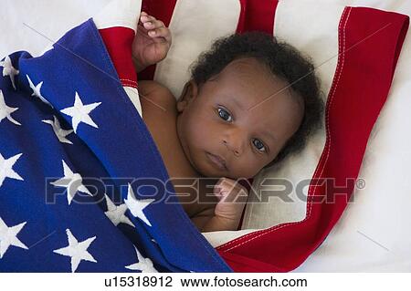 Stock Image - Baby wrapped in American flag. Fotosearch