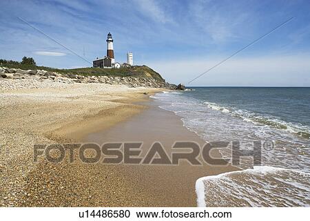Beach with lighthouse in background View Large Photo Image Stock Image - Beach with lighthouse in background. Fotosearch