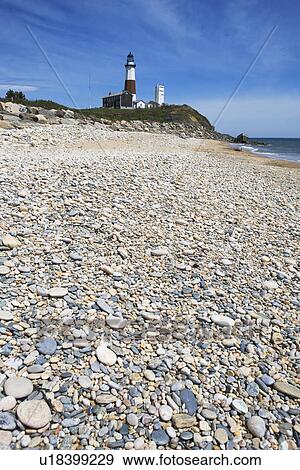 Beach with lighthouse in background View Large Photo Image Stock Photo - Beach with lighthouse in background. Fotosearch
