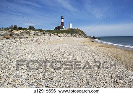 Stock Photograph - Beach with lighthouse in background. Fotosearch