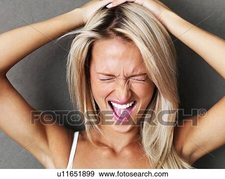 Stock Photo - Beautiful blond woman screaming. Fotosearch