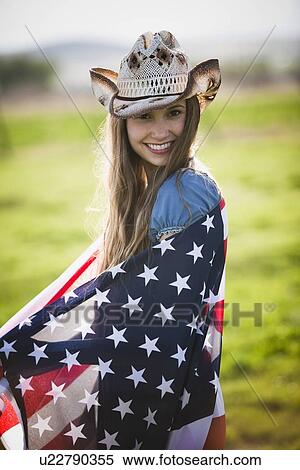 Beautiful cowgirl wrapped in American flag View Large Photo Image Stock Photography - Beautiful cowgirl wrapped in American flag. Fotosearch
