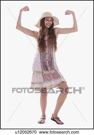 Stock Image - Beautiful long haired woman flexing her muscles. Fotosearch