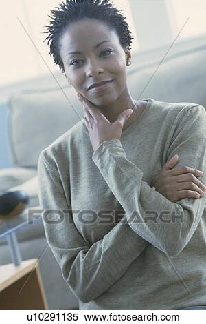 Stock Photography - Beautiful woman standing in her home. Fotosearch