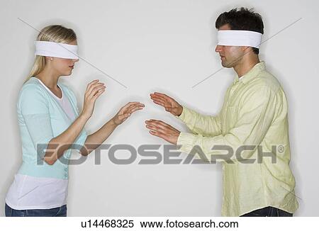 Blindfolded couple looking for each other View Large Photo Image Stock Photography - Blindfolded couple looking for each other. Fotosearch
