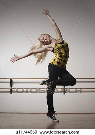 Stock Photo - Blond woman dancing in ballet studio. Fotosearch