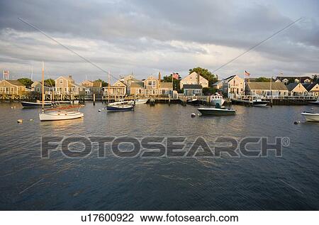 Boats in harbor with village in background View Large Photo Image Stock Image - Boats in harbor with village in background. Fotosearch