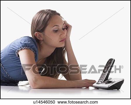 Bored woman waiting for the phone to ring View Large Photo Image Stock Image - Bored woman waiting for the phone to ring. Fotosearch
