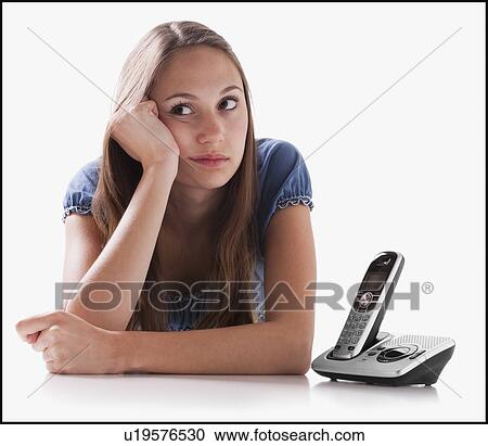 Bored woman waiting for the phone to ring View Large Photo Image Stock Image - Bored woman waiting for the phone to ring. Fotosearch