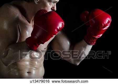 Boxer wearing red boxing gloves View Large Photo Image Stock Photograph - Boxer wearing red boxing gloves. Fotosearch