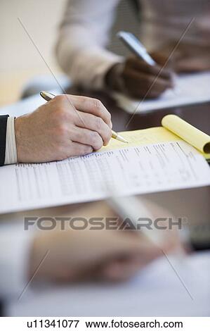 Business people writing notes during business meeting View Large Photo Image Stock Photo - Business people writing notes during business meeting. Fotosearch