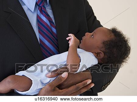 Businessman holding baby View Large Photo Image Stock Image - Businessman holding baby. Fotosearch