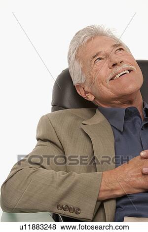 Businessman relaxing at his desk View Large Photo Image Stock Photo - Businessman relaxing at his desk. Fotosearch