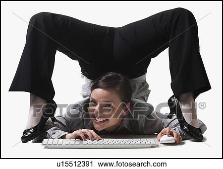 Businesswoman contorting her body while typing View Large Photo Image Stock Image - Businesswoman contorting her body while typing. Fotosearch
