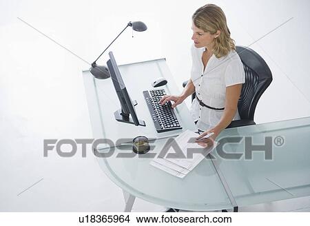 Picture - Businesswoman working on computer. Fotosearch