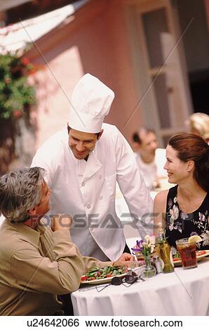 Stock Photograph - Chef talking to patron. Fotosearch