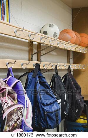 Children's backpacks hanging on hooks in classroom View Large Photo Image Stock Image - Children's backpacks hanging on hooks in classroom. Fotosearch