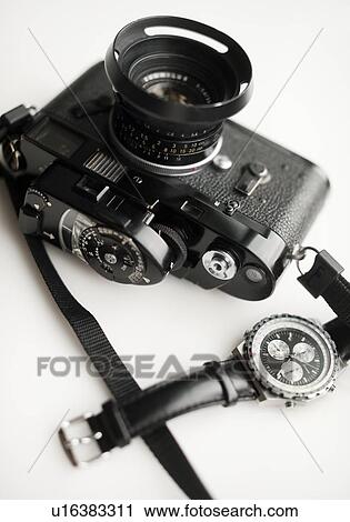 Stock Image - Classic camera and watch. Fotosearch