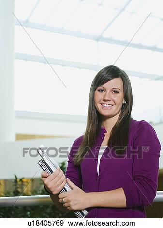 College student holding books View Large Photo Image Stock Photo - College student holding books. Fotosearch