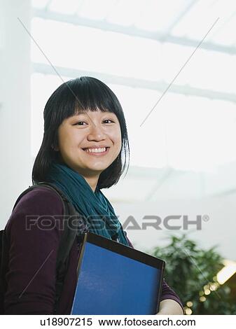 Stock Photography - College student holding books. Fotosearch