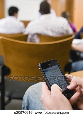 College student texting in lecture hall View Large Photo Image Stock Photograph - College student texting in lecture hall. Fotosearch