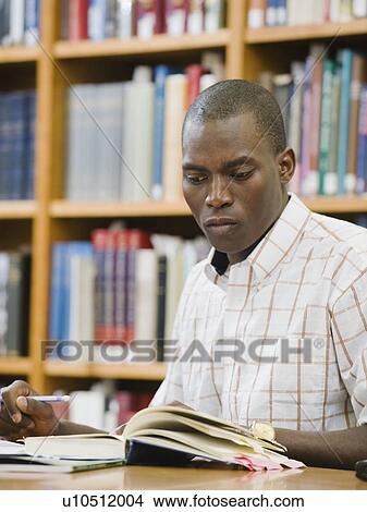 College student working in library View Large Photo Image Picture - College student working in library. Fotosearch