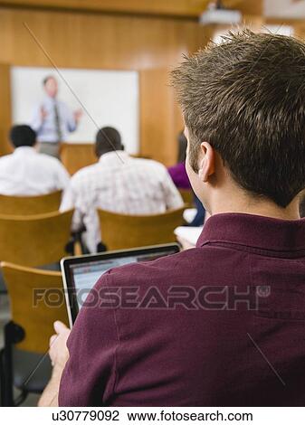 Stock Image - College students in lecture hall. Fotosearch