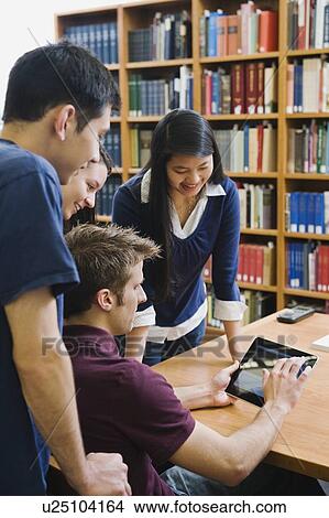 College students looking at electronic book View Large Photo Image Picture - College students looking at electronic book. Fotosearch