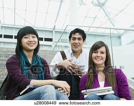 College students sitting on steps in front of library View Large Photo Image Stock Photo - College students sitting on steps in front of library. Fotosearch