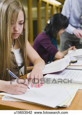 Stock Image - College students working in library. Fotosearch
