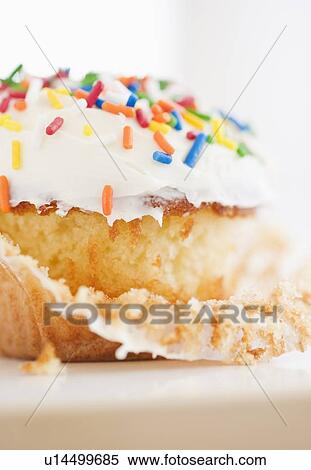 Stock Photography - Colorful sprinkles on cupcake. Fotosearch