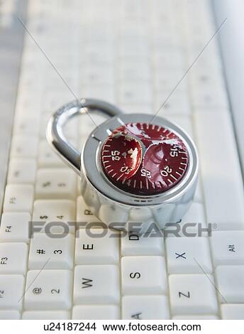 Picture - Combination lock on top of keyboard. Fotosearch